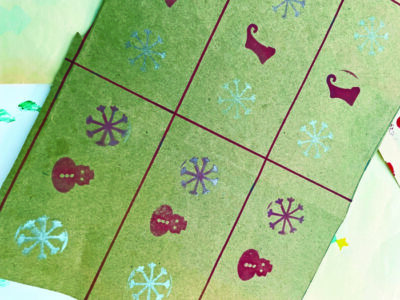 brown paper with metallic ink stamps in a repeating pattern along a wide, rectangular grid.